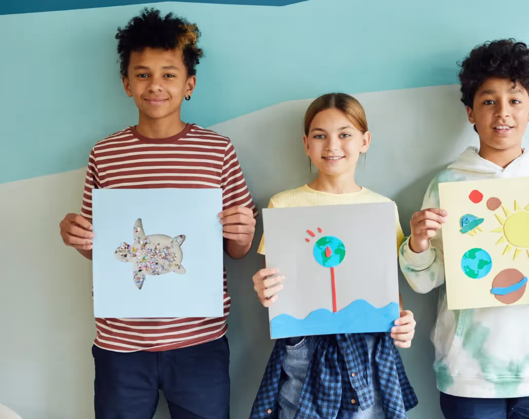 A group of kids holding up pictures of themselves